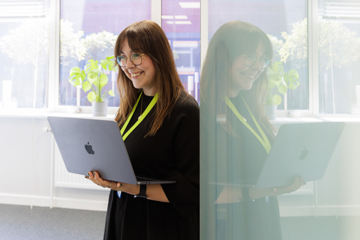 Lydia Davies standing in the doorway with her laptop